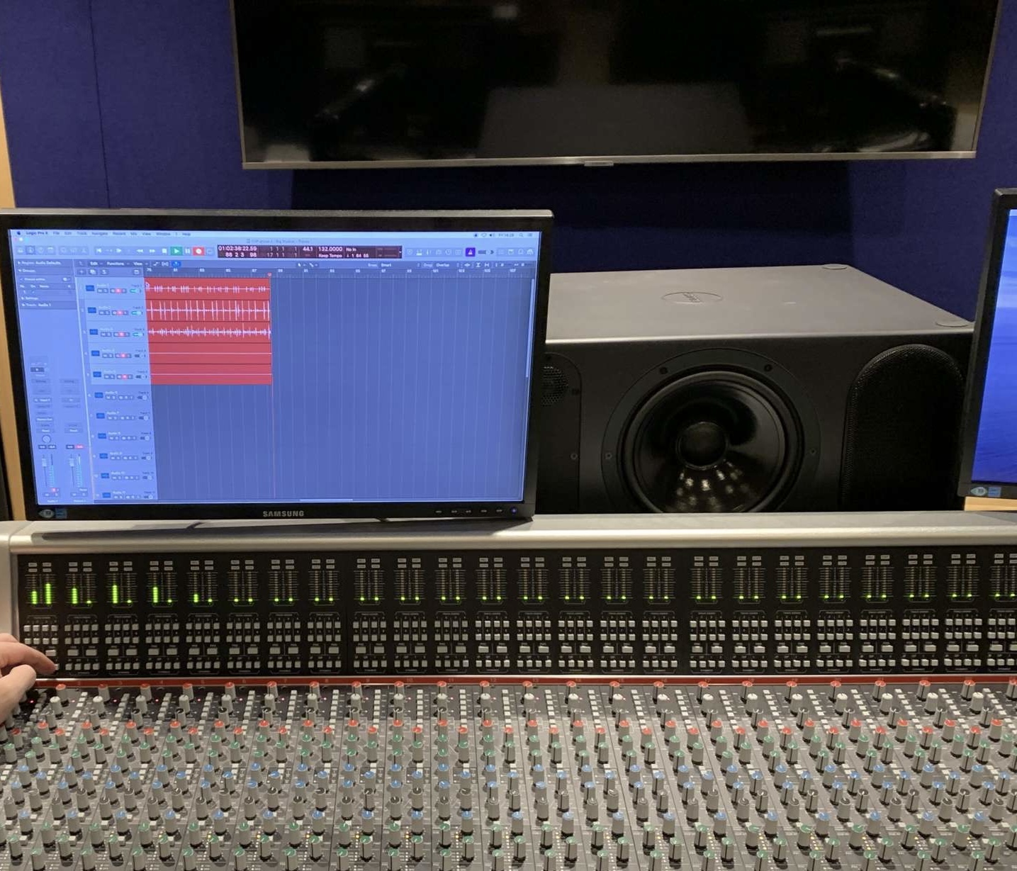 Studio desk with Logic on the screen.