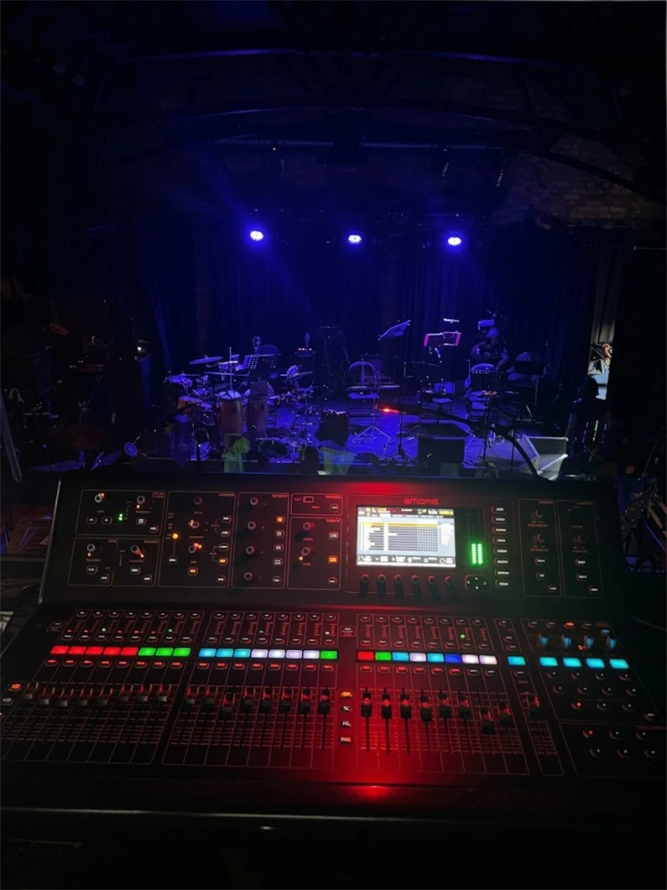 My mixing desk with a view of a live set-up in the background.